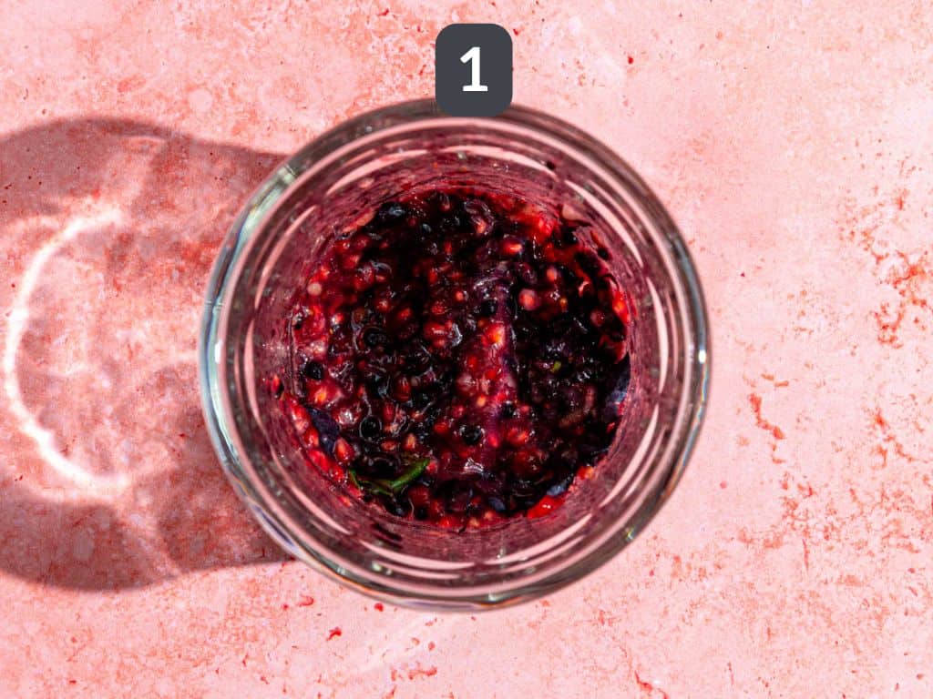 Mixed berry mocktail step 1 - muddle the berries.