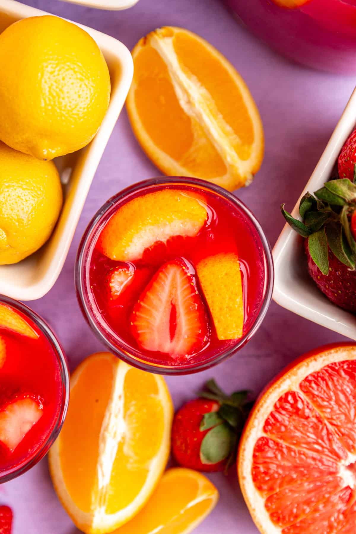 A glass of easter mocktail viewed from the top down to see the fruit pieces in the glass.