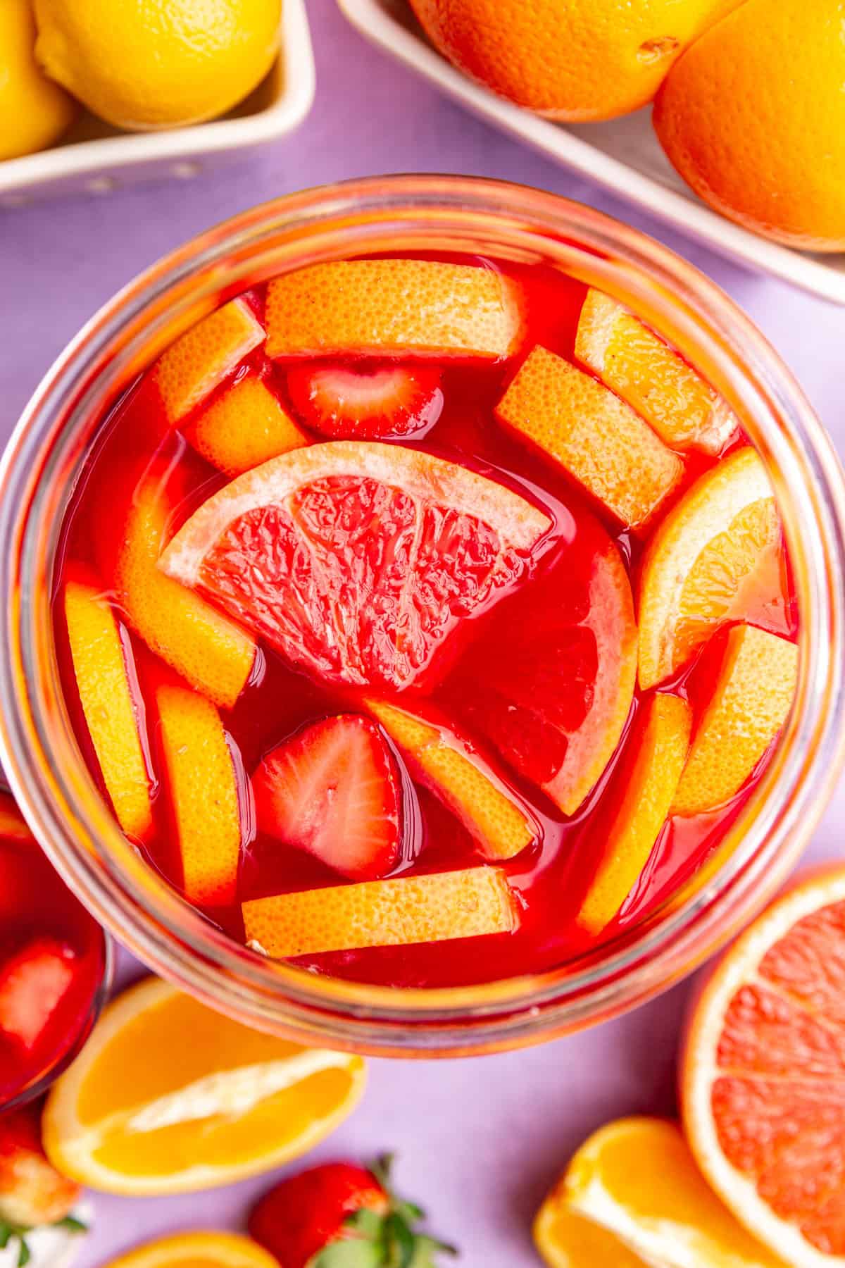 A punch bowl of easter mocktail viewed from the top down to see the fruit pieces in the bowl.