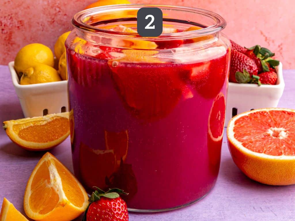 Easter mocktail step 2 - add the seltzer and fruit.