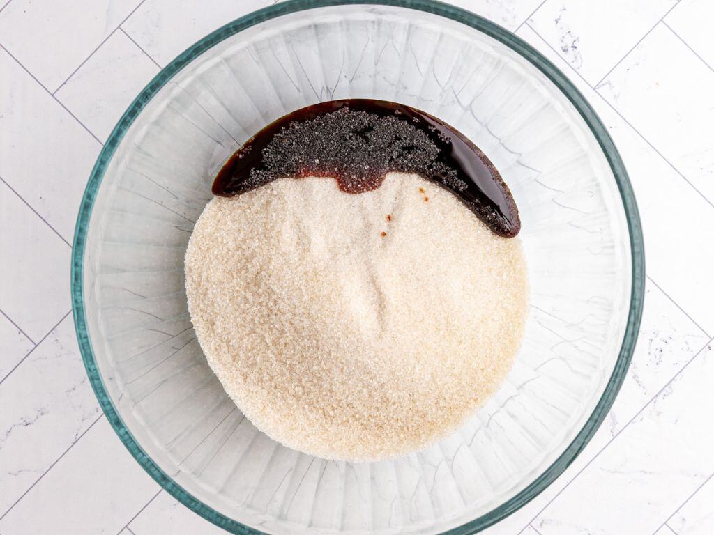 A bowl of sugar and molasses, before mixing into brown sugar.