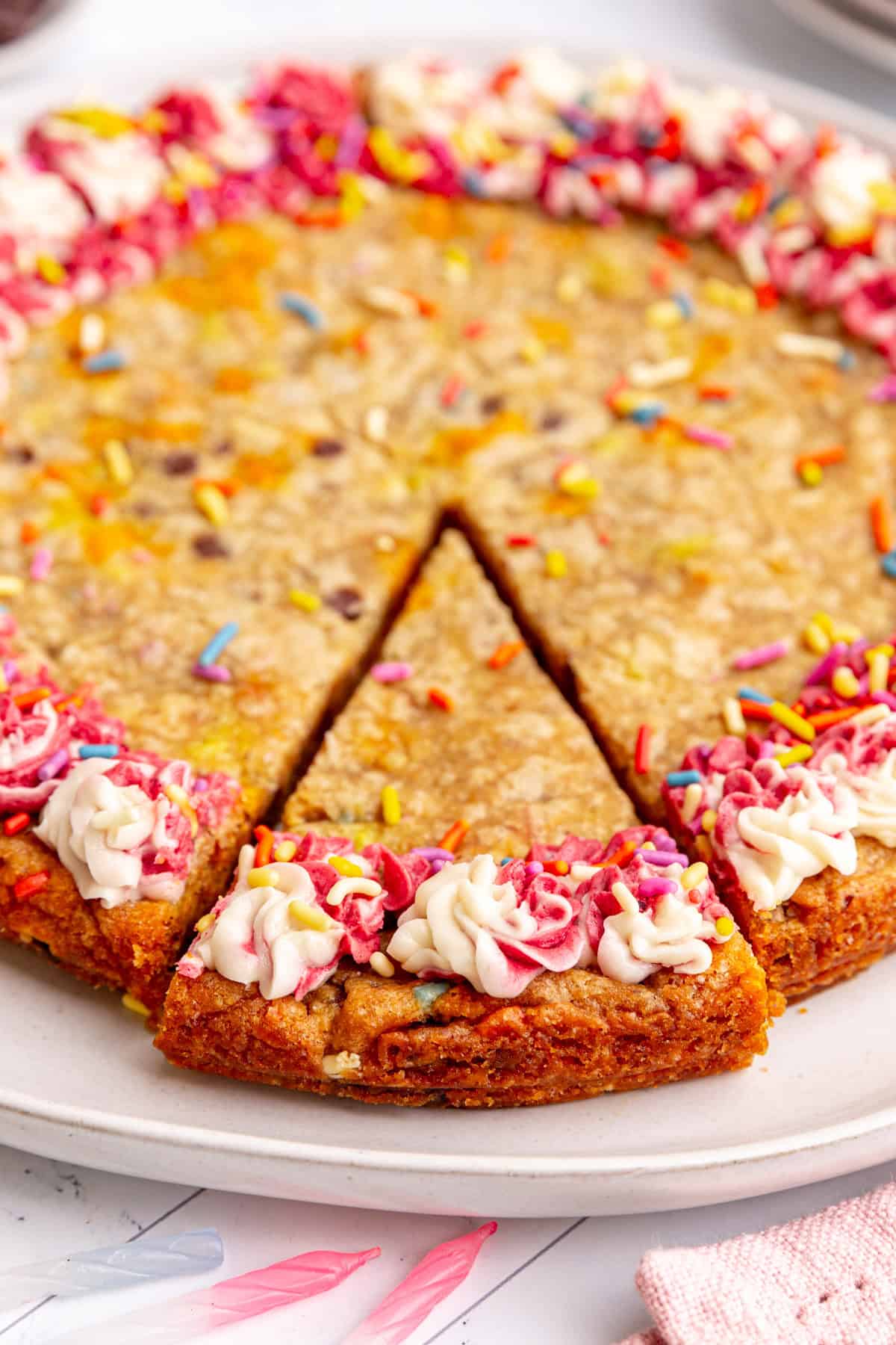 A slice cut out of a vegan cookie cake, ready to serve.