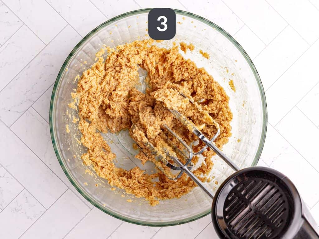 Vegan cookie cake step 3 - add the milk, flax, vanilla, almond extract and beat again.