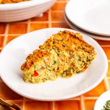 A slice of vegan frittata on a plate, ready to eat.