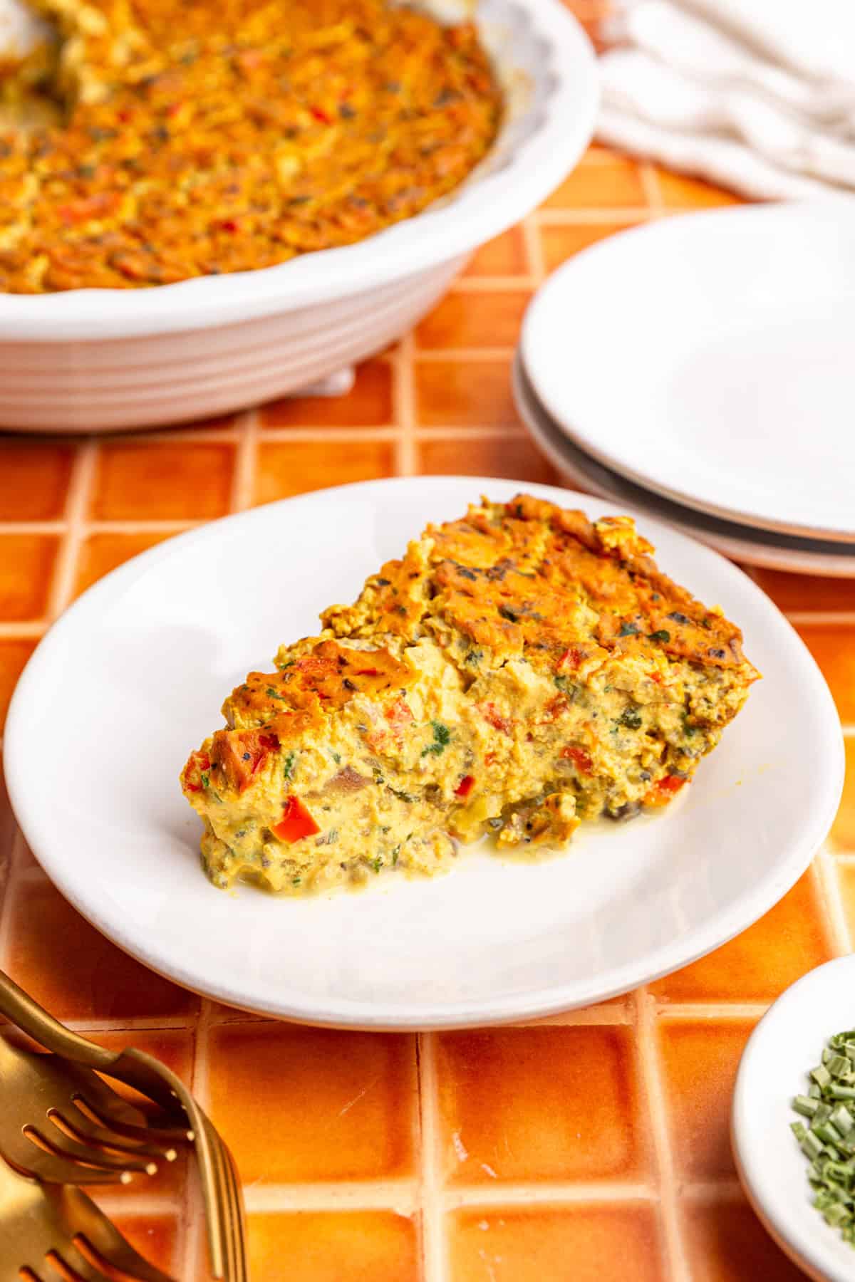 A slice of vegan frittata on a plate, ready to eat.