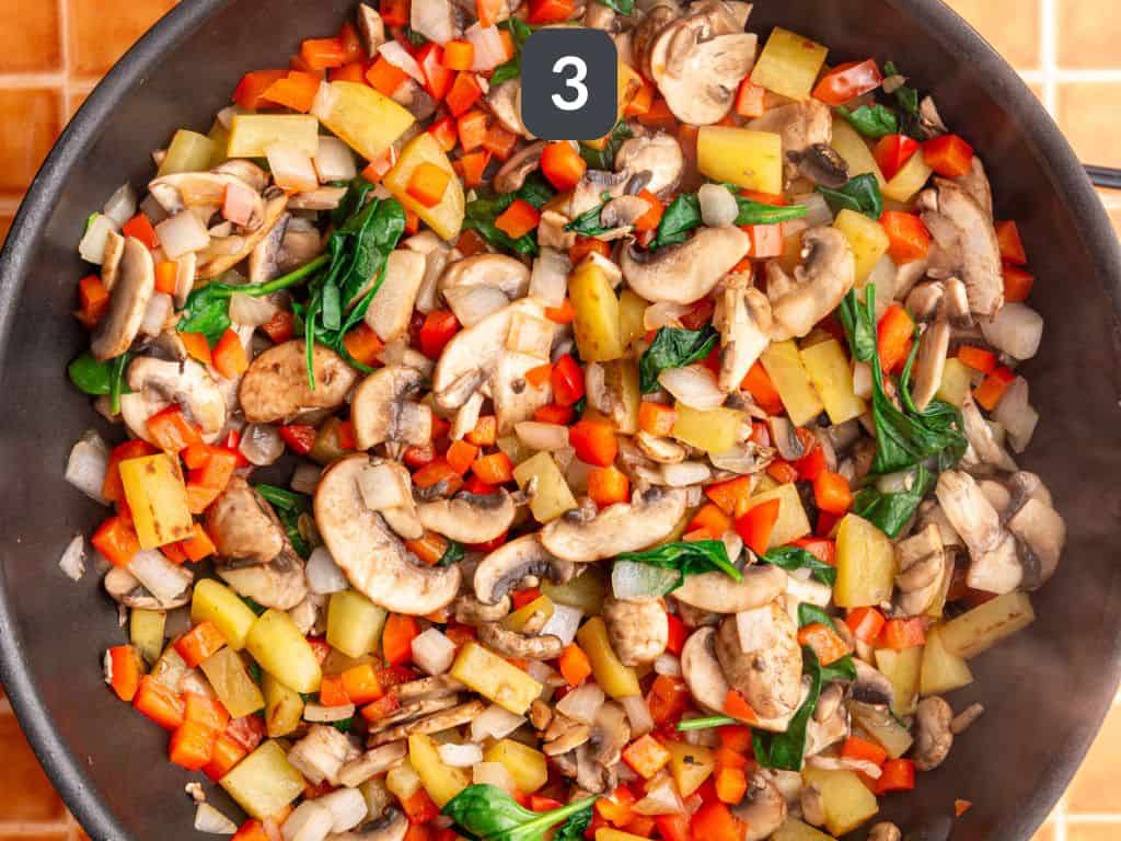 Vegan frittata step 3 - add the veggies and cook.