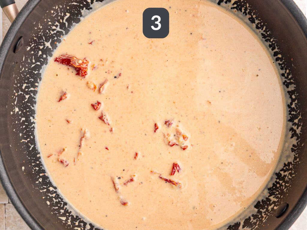 Vegan sundried tomato pasta step 3 - add the coconut milk and stir.