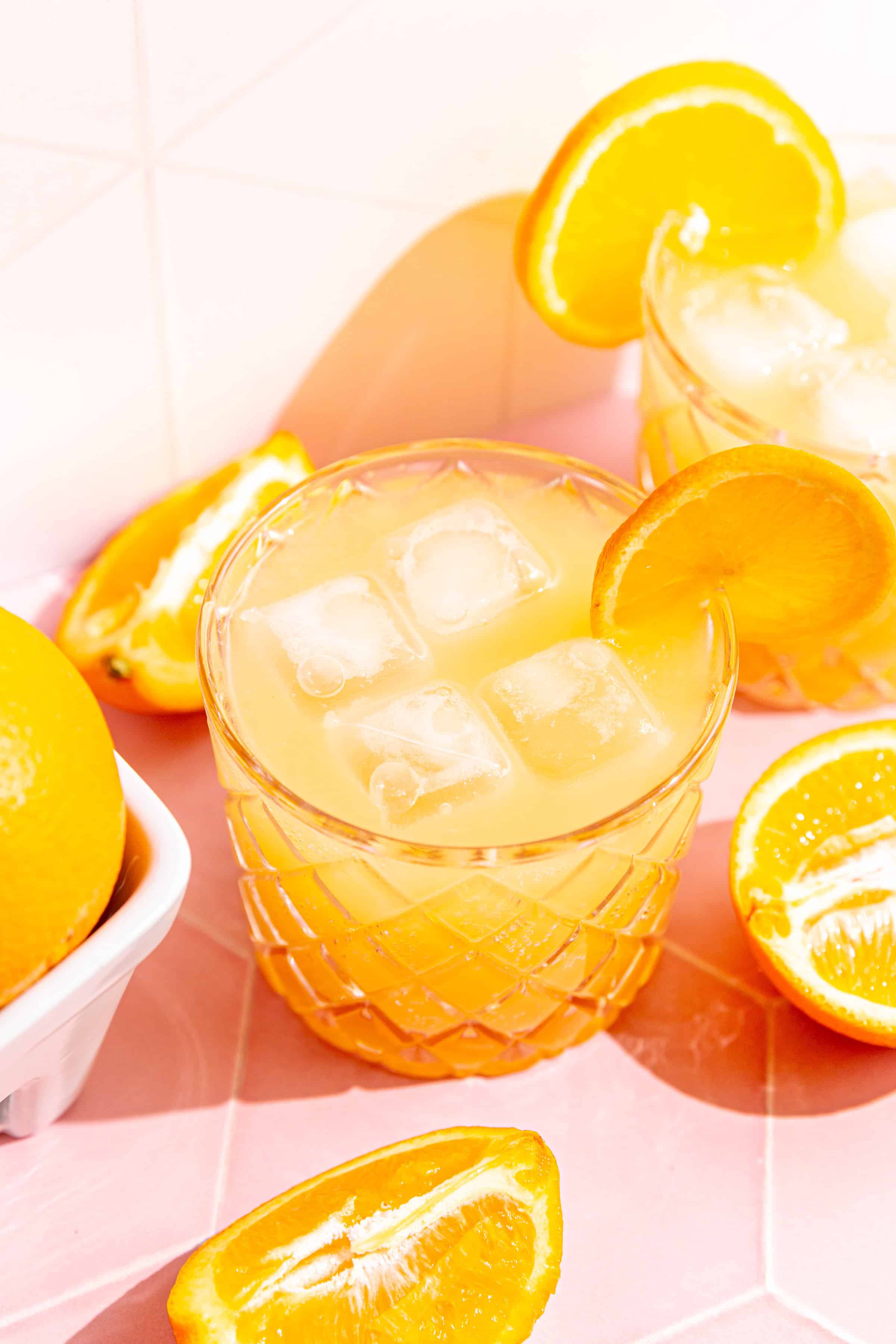An aperol spritz mocktail on a sunny countertop.