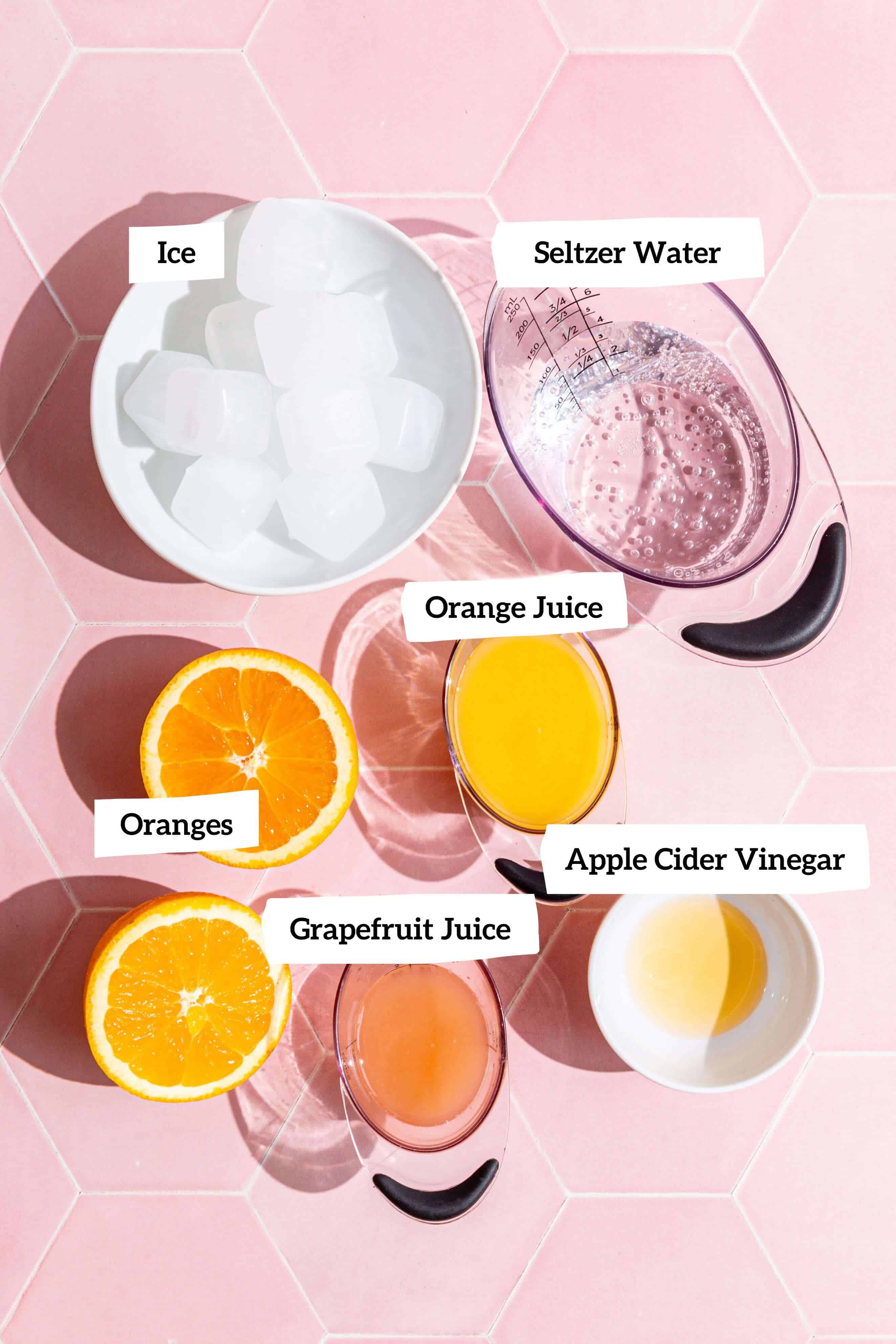 The ingredients for an aperol spritz mocktail.
