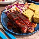A plate of bbq seitan ribs, cornbread, and coleslaw.
