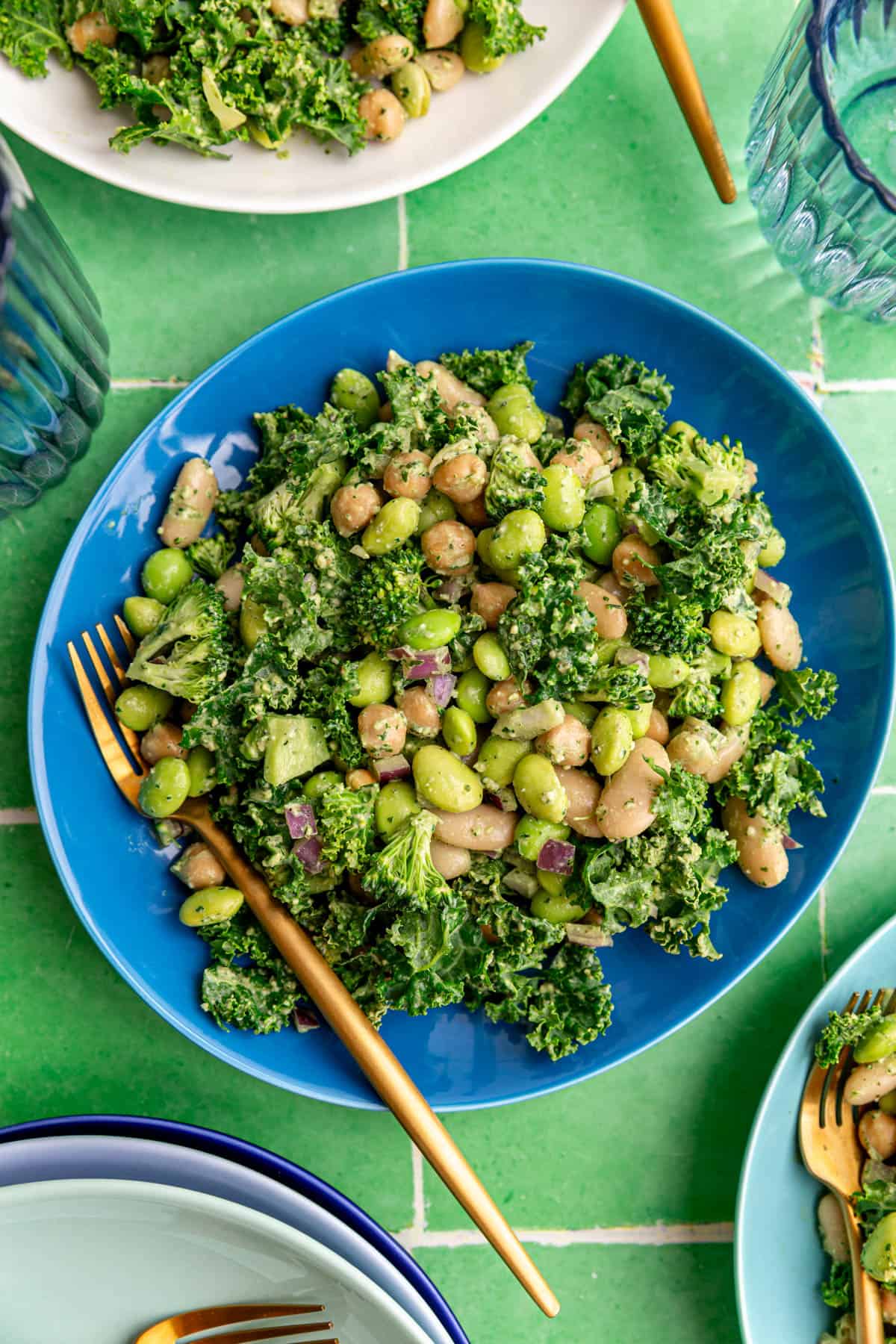 A plate of pesto bean salad, with a fork, ready to eat.