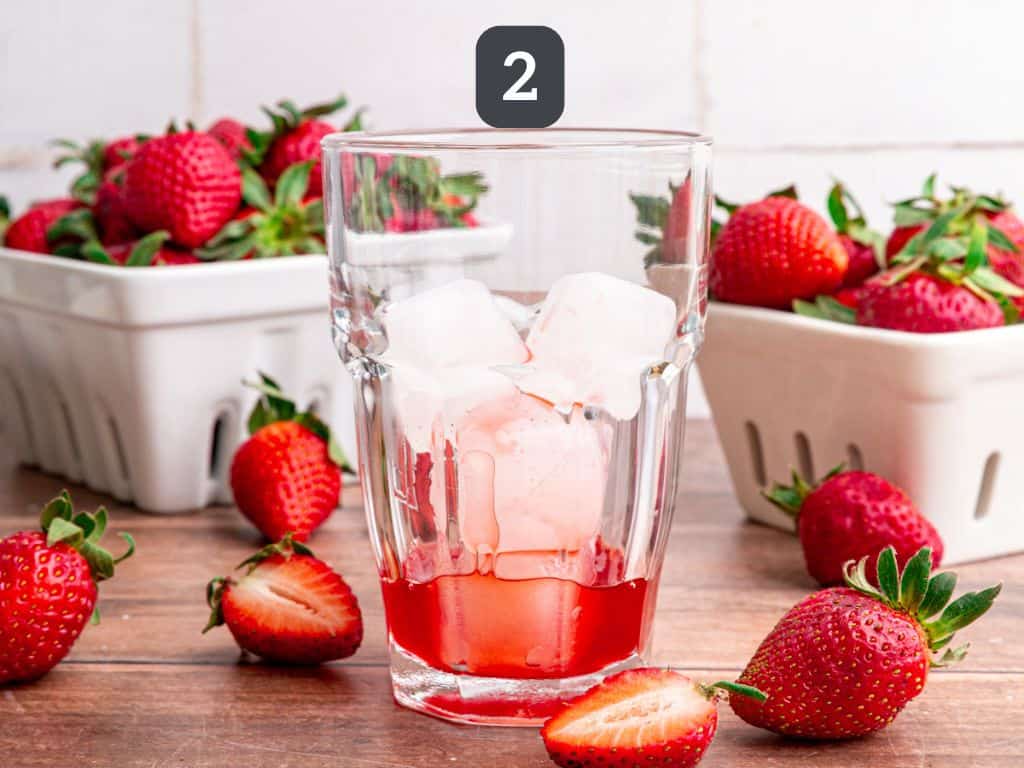 Strawberry cream soda step 2 - add the strawberry syrup.