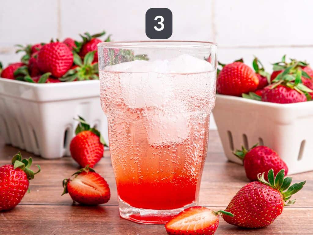 Strawberry cream soda step 3 - pour on the seltzer.