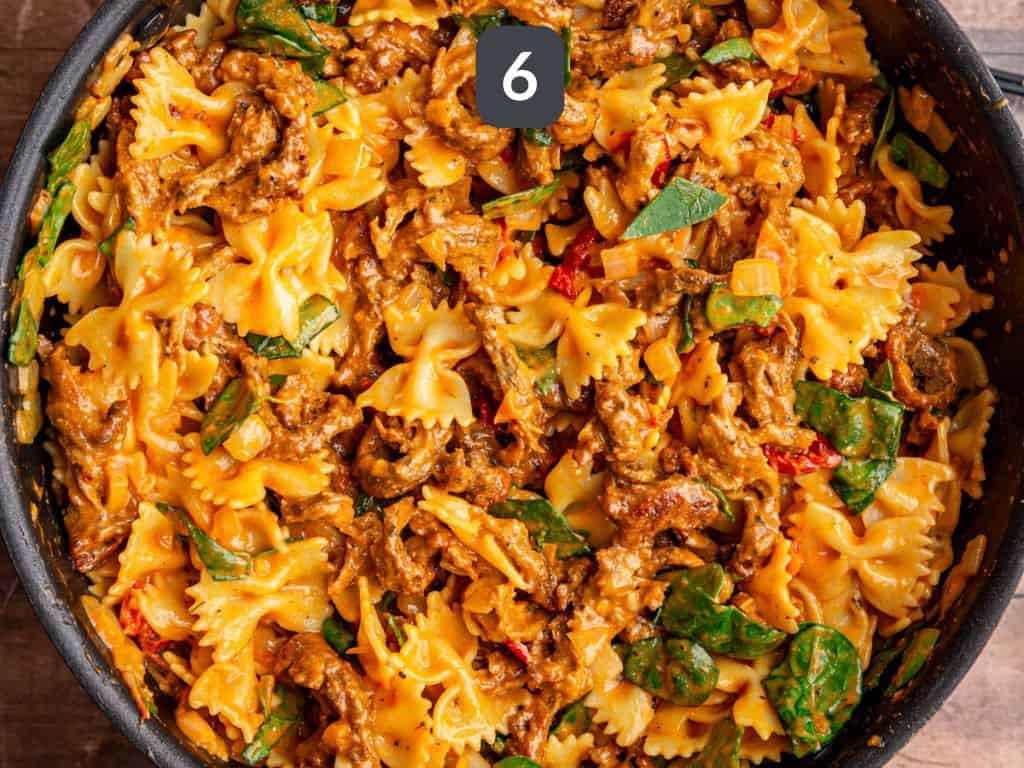 Vegan Marry Me Pasta Step 6 - toss all the pasta, chicken, and spinach.