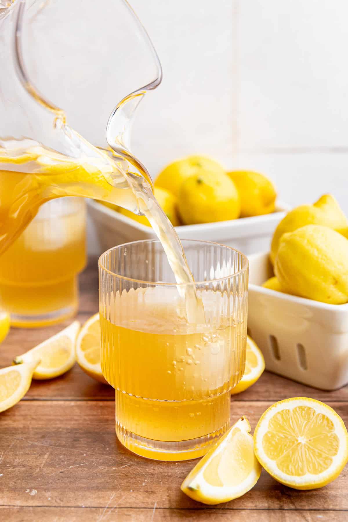 A glass of brown sugar lemonade being poured.
