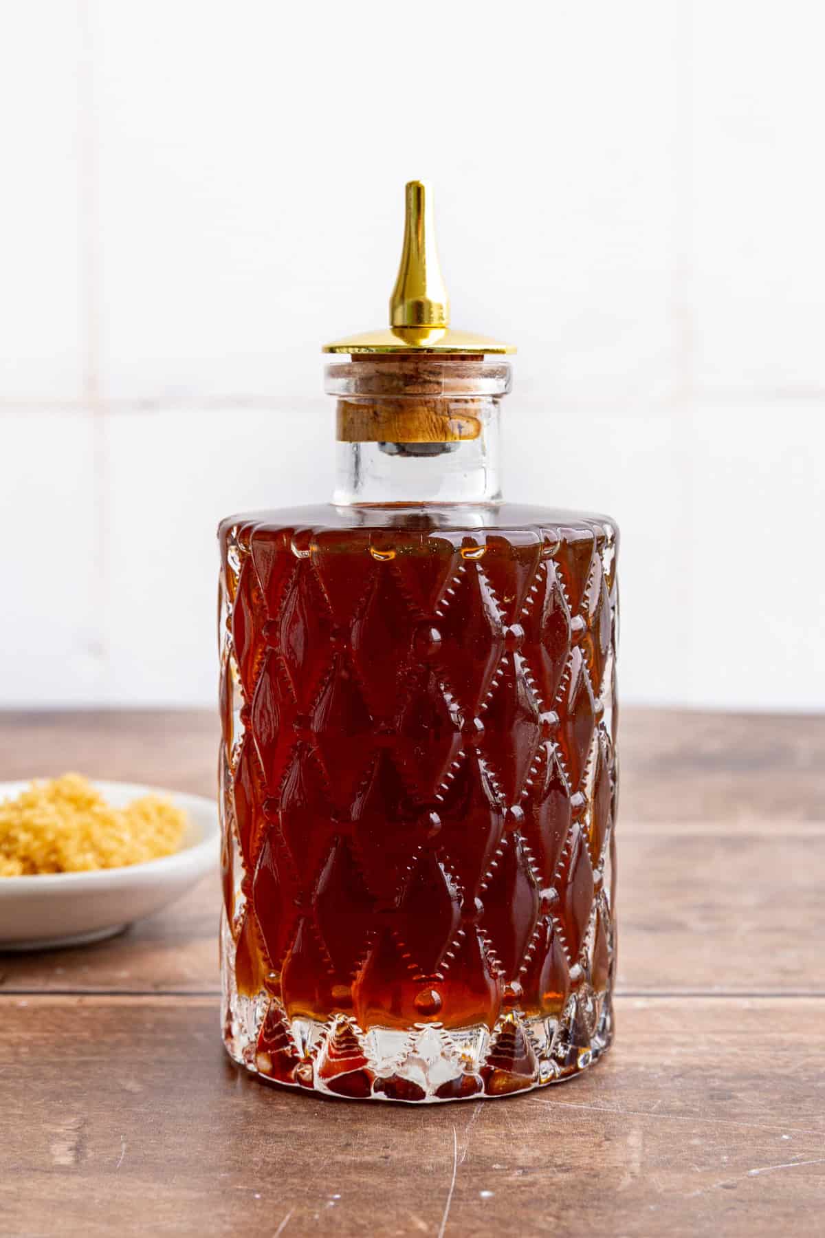 A bitters bottle full of brown sugar simple syrup.