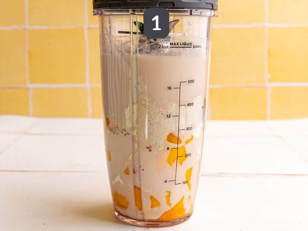 Vegan mango smoothie step 1 - add the ingredients to a blender.