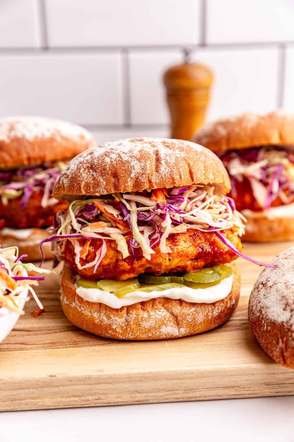 A vegan nashville hot chicken sandwich, with slaw, pickles, and mayo.