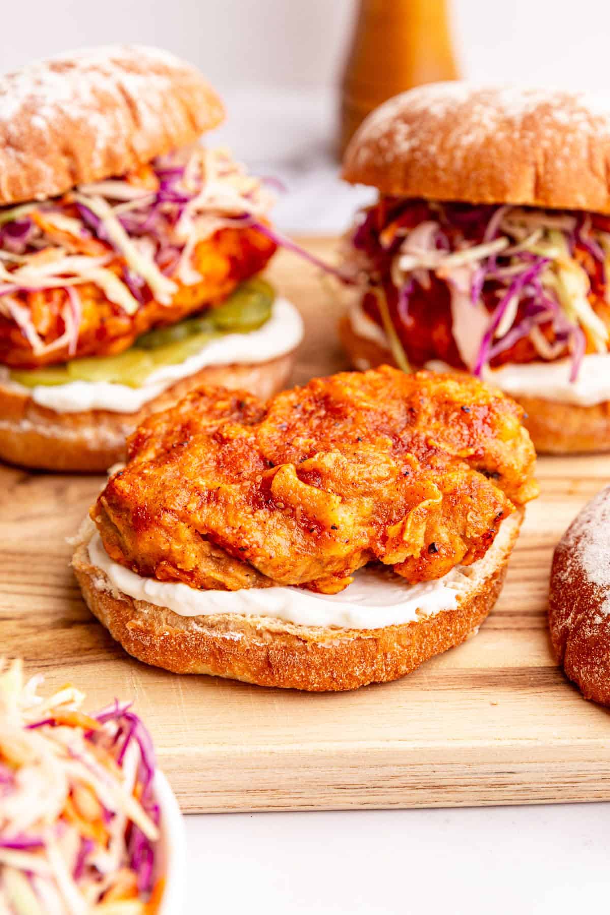 A vegan nashville hot chicken sandwich being assembled.
