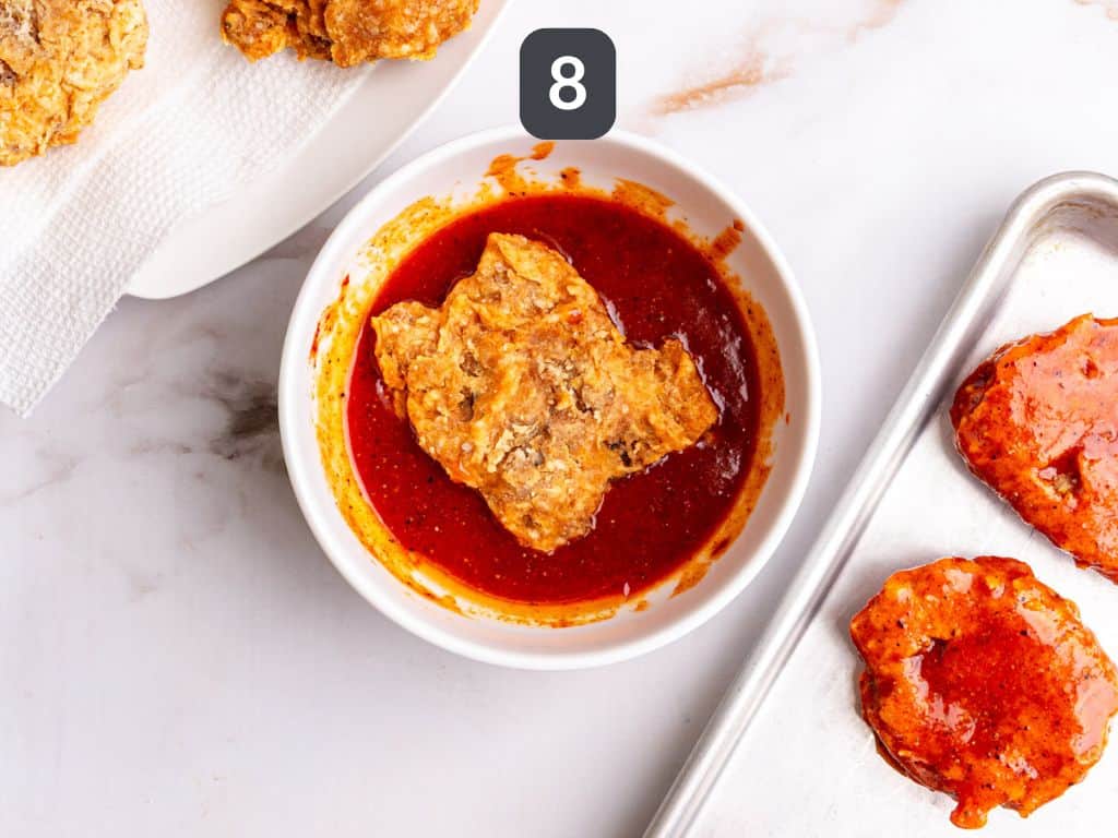 Vegan Nashville Hot Chicken Step 8 - coat the fried chicken in hot sauce.