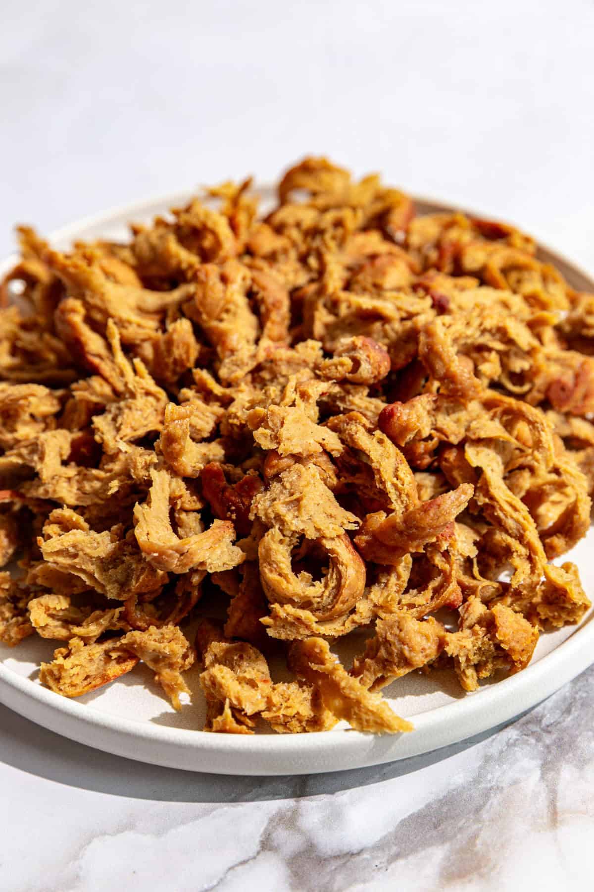 A plate of vegan shredded chicken.