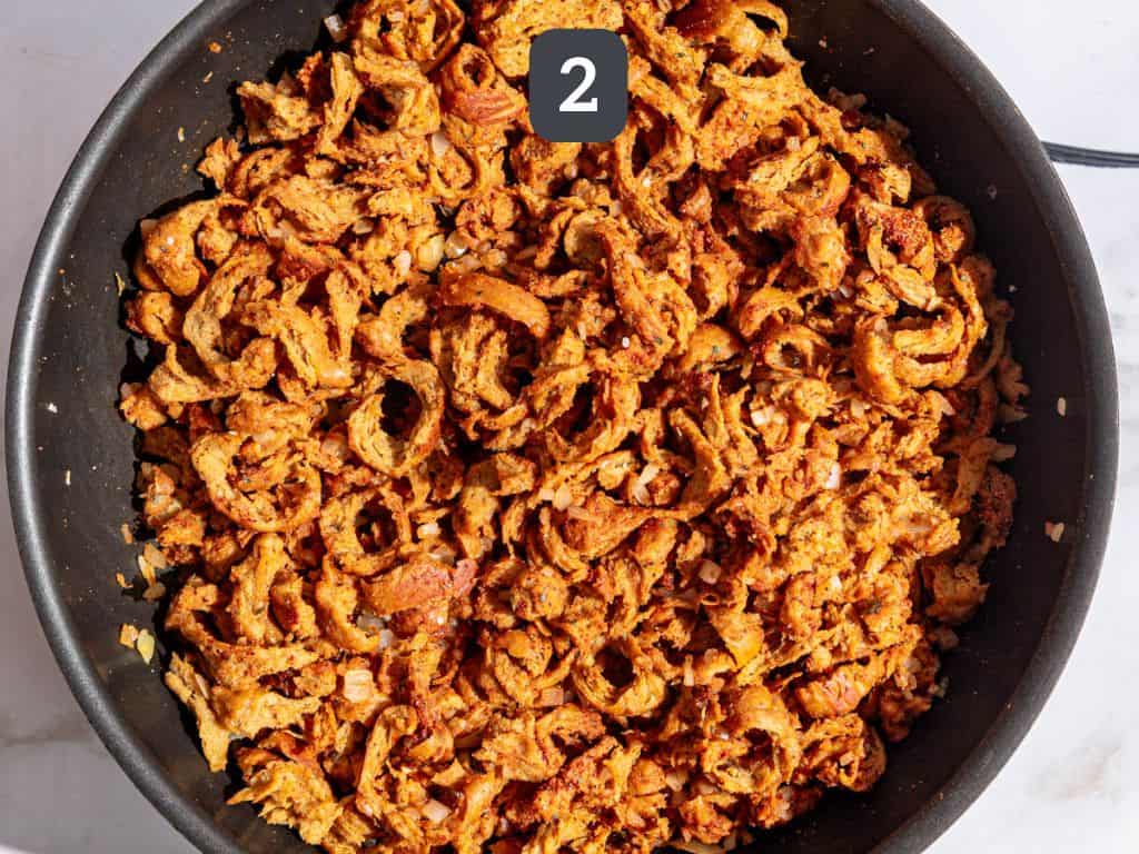 Vegan shredded chicken tacos step 2 - add the chicken, water, and spices.