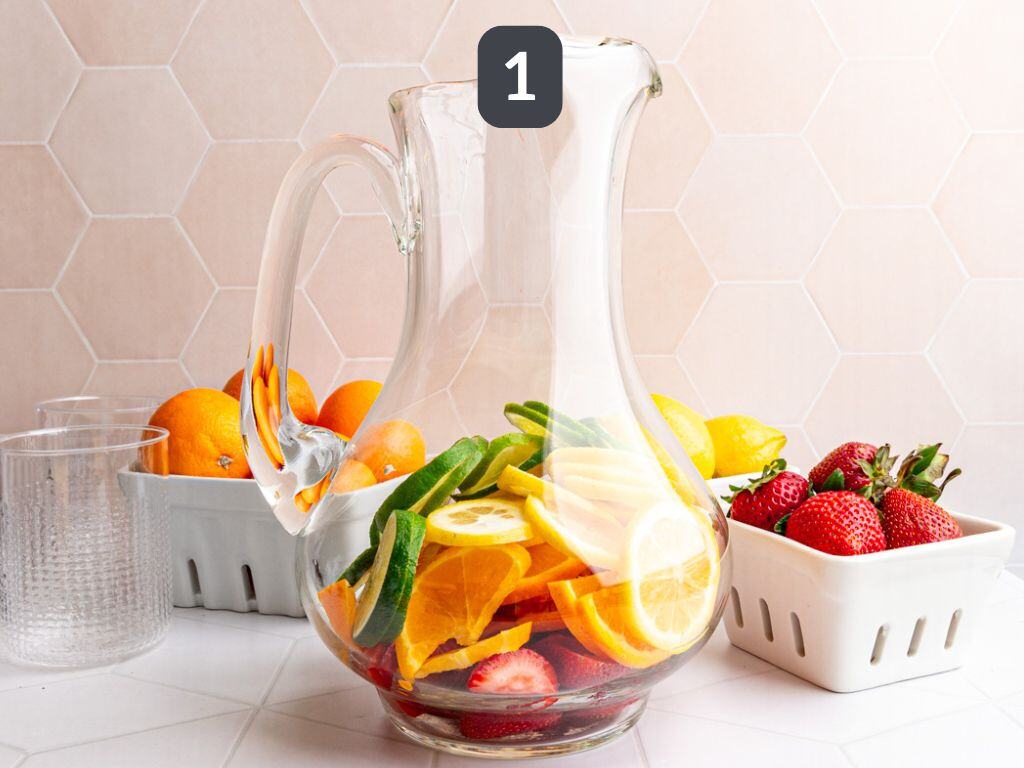 White Sangria Mocktail step 1 - add the fruit to your pitcher.