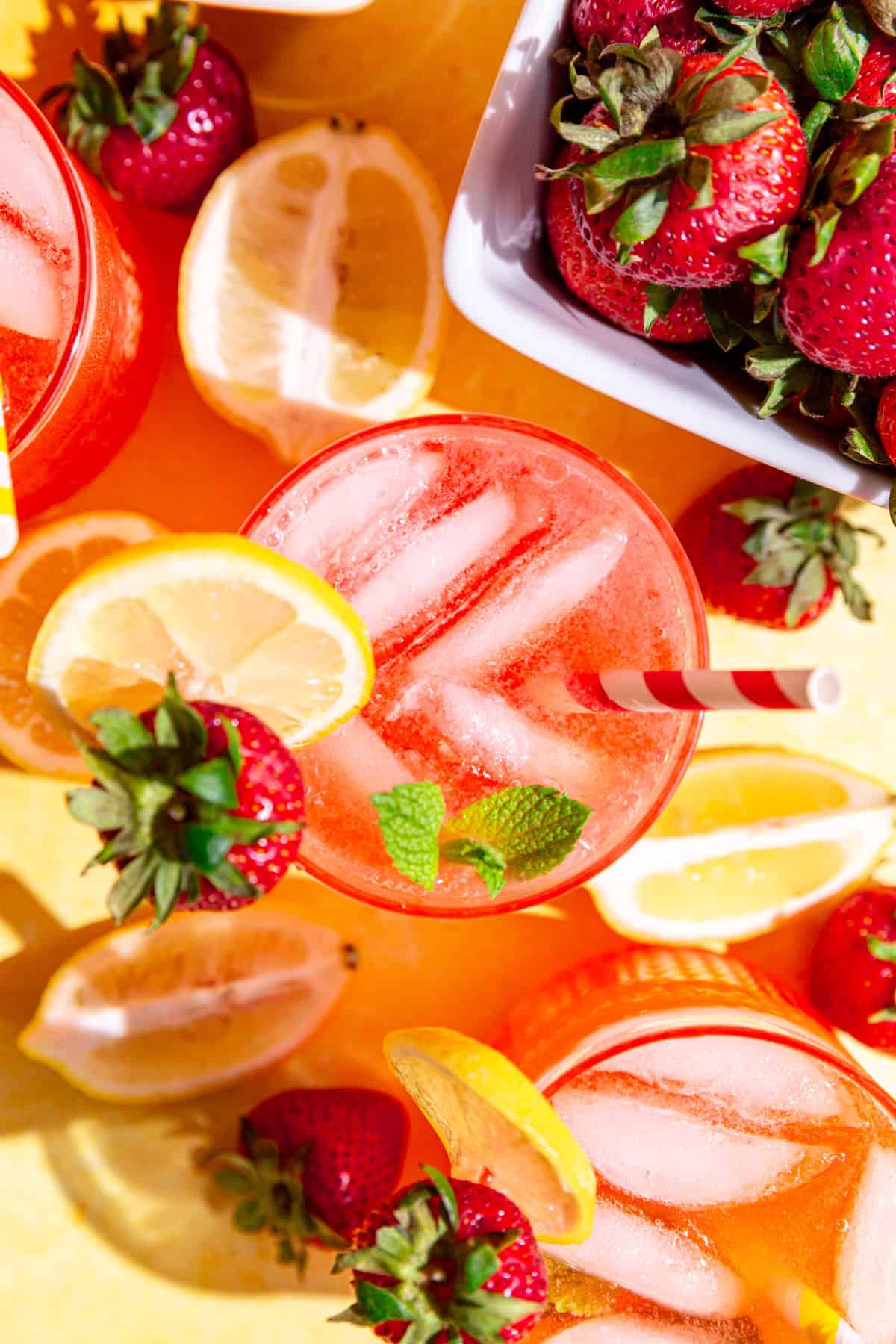 A top down view of several strawberry pink lemonade mocktails.