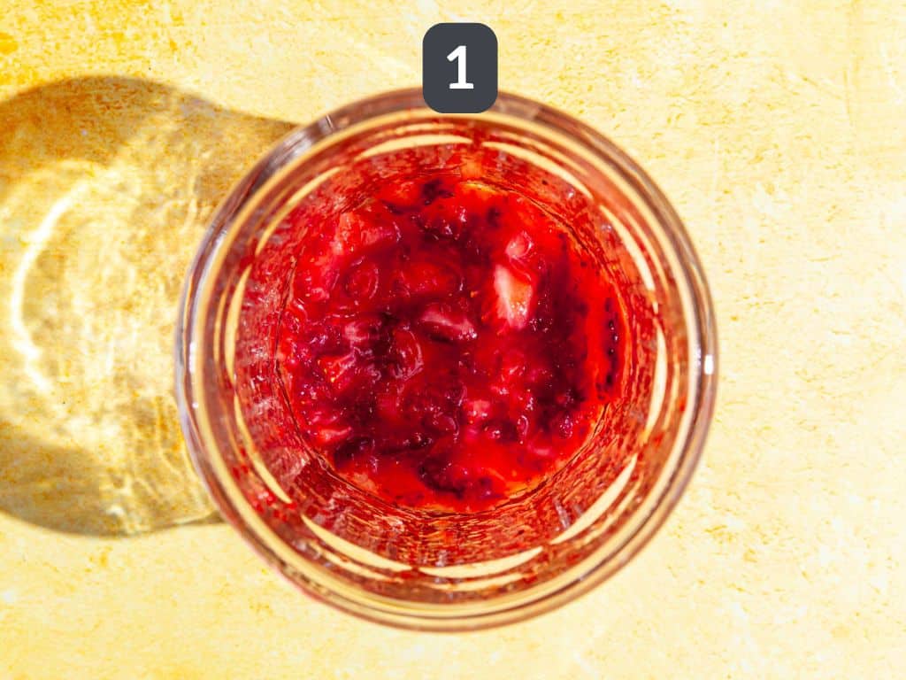 Strawberry Pink Lemonade Mocktail step 1 - muddle the strawberries.