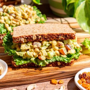 A curry chickpea salad sandwich, with lettuce and sandwich bread.