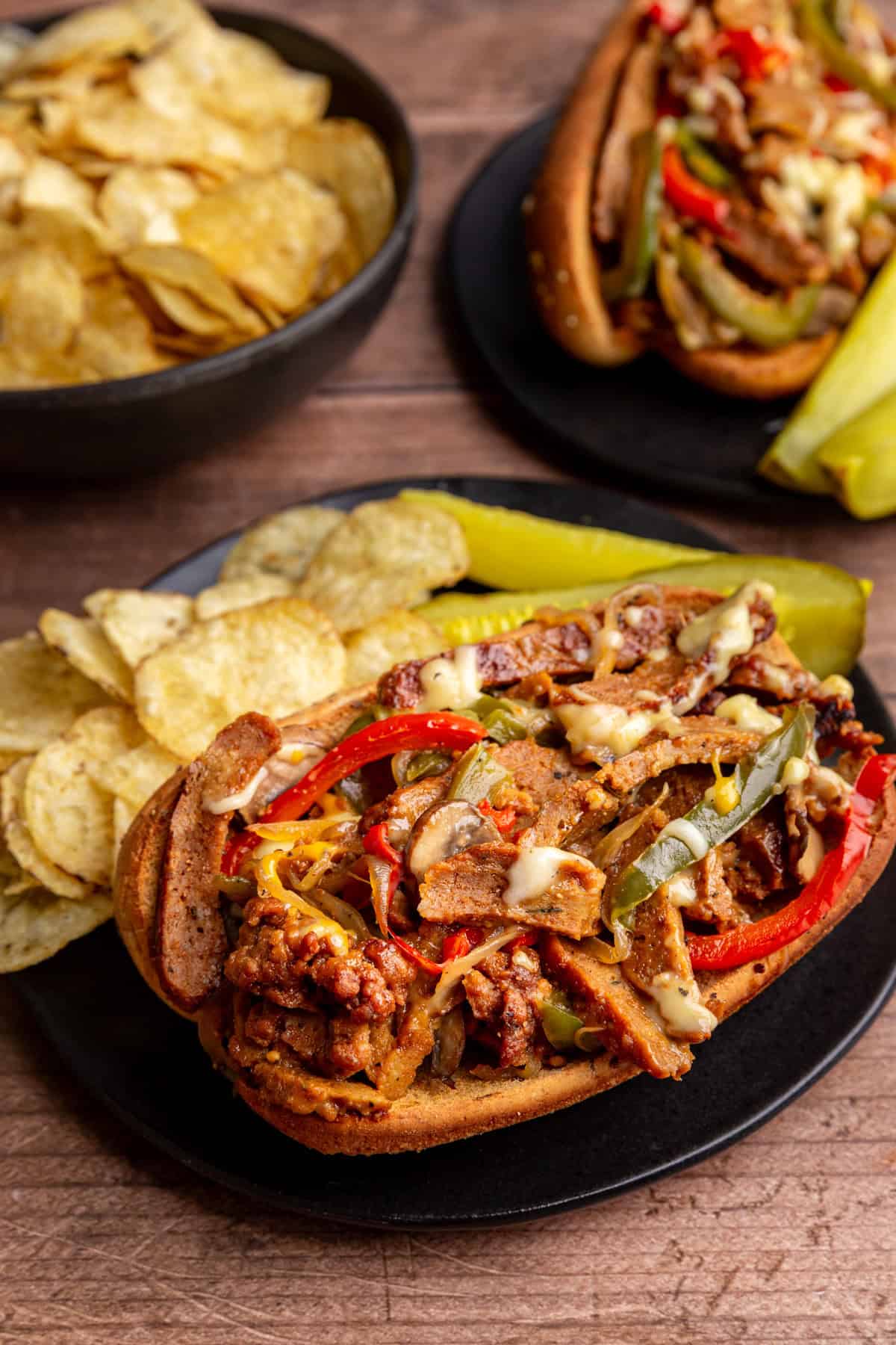 A close up view of a loaded, cheesy, vegan Philly cheesesteak.