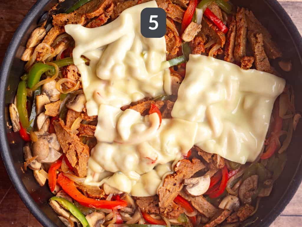 Vegan Philly Cheesesteak Step 5 - add the cheese and cover to melt.