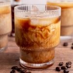 An iced Brown Sugar Oat Milk Latte with the milk and coffee swirling together.