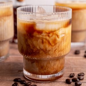 An iced Brown Sugar Oat Milk Latte with the milk and coffee swirling together.