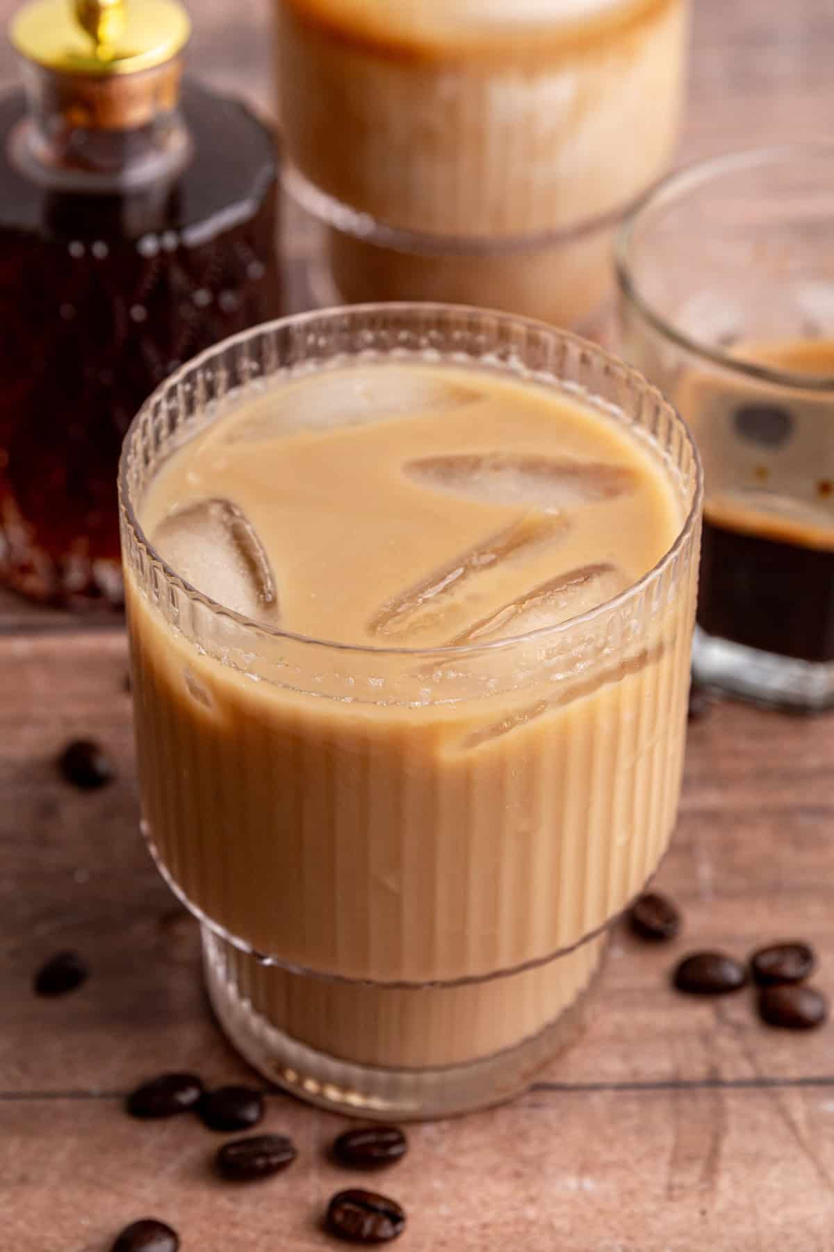 An iced Brown Sugar Oat Milk Latte that has been stirred.