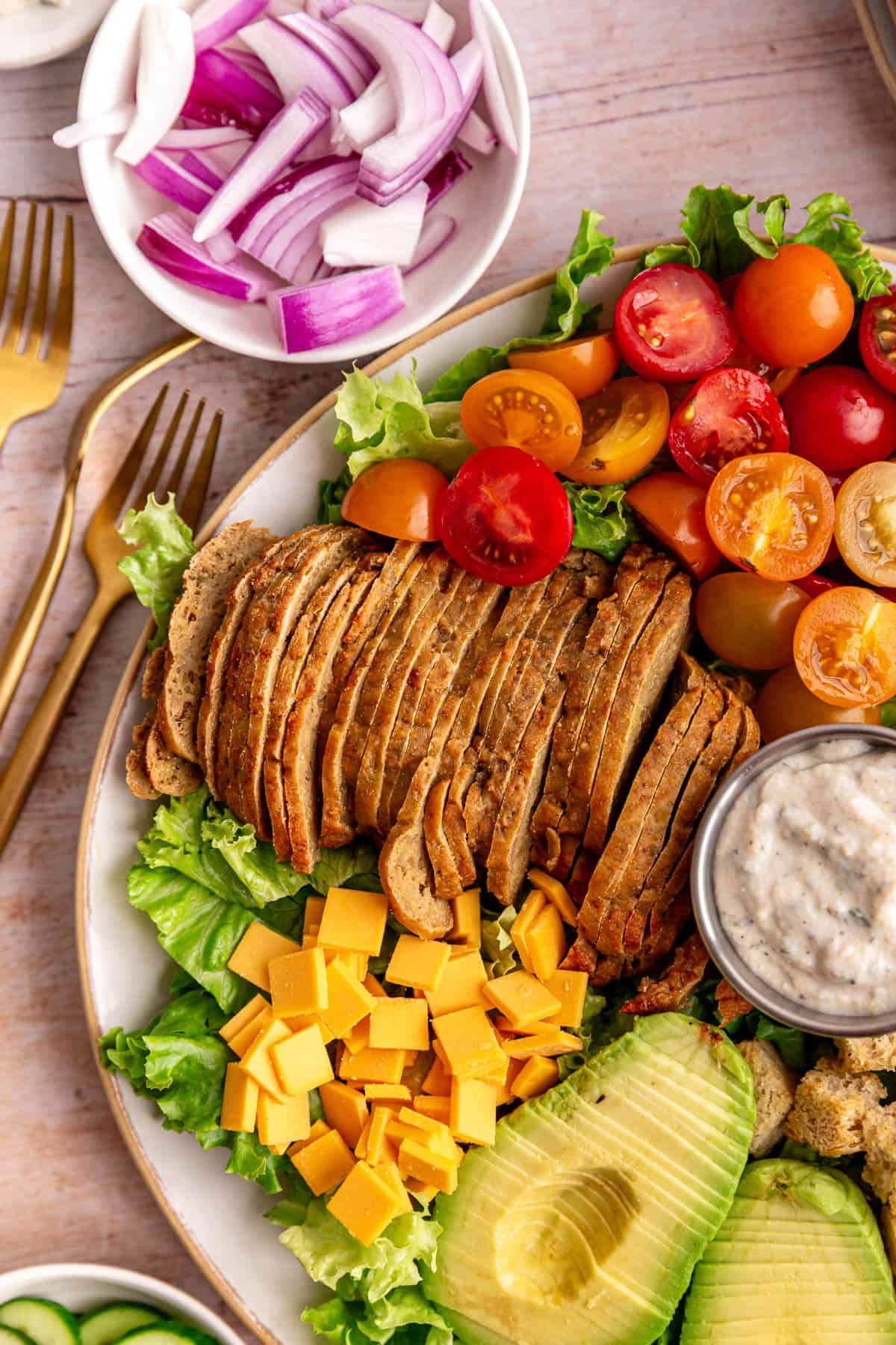 A close up view of the chefs salad, to see the turkey, cheese, and tomato.