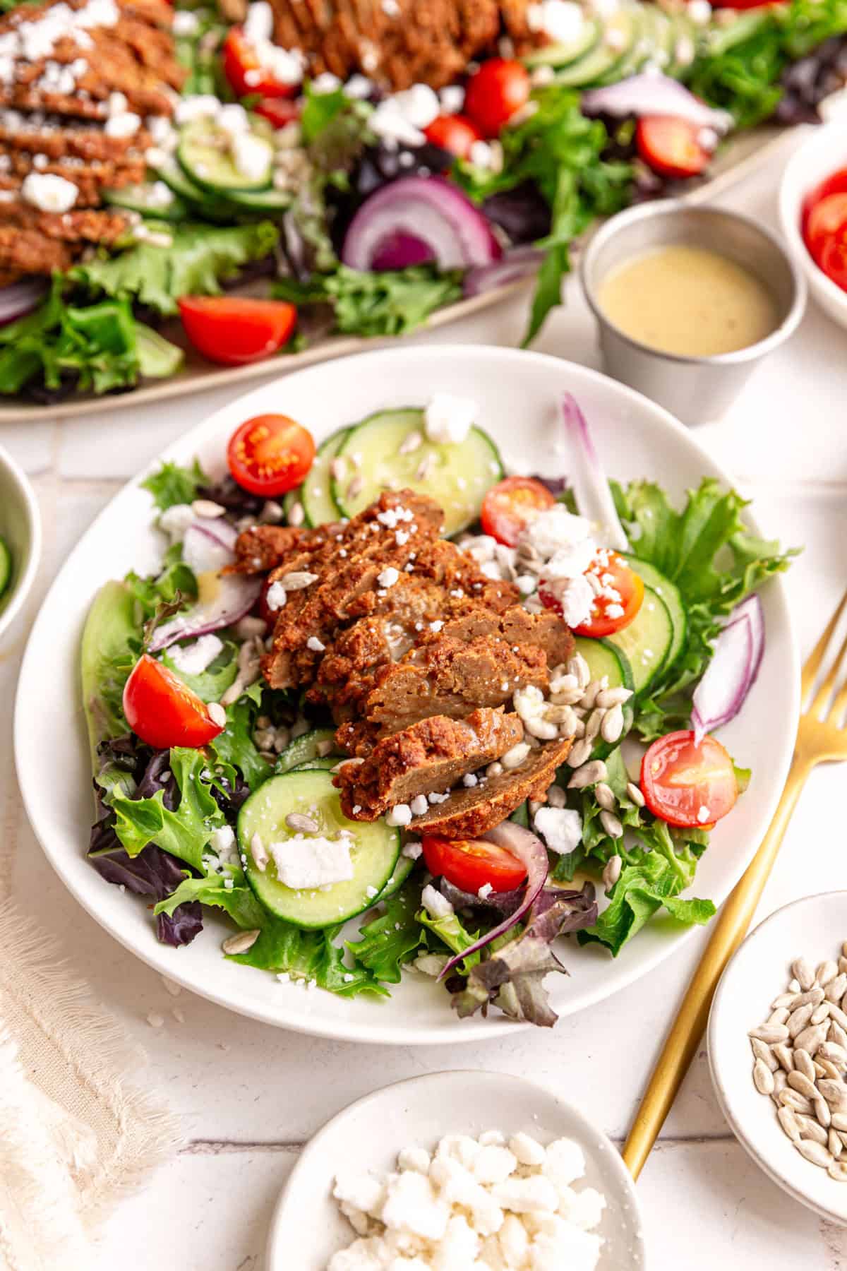A plate of vegan steak salad, ready to eat.