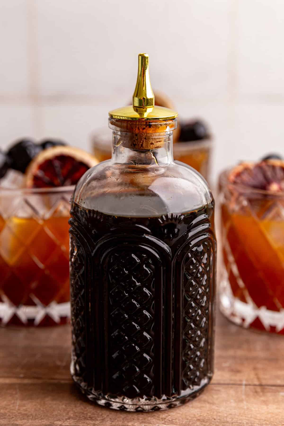 A jar of coconut sugar simple syrup, with a few whiskey sour mocktails.