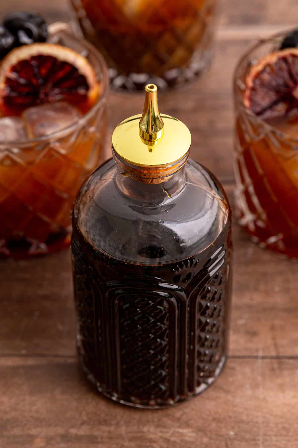 A jar of coconut sugar simple syrup, with a few whiskey sour mocktails.