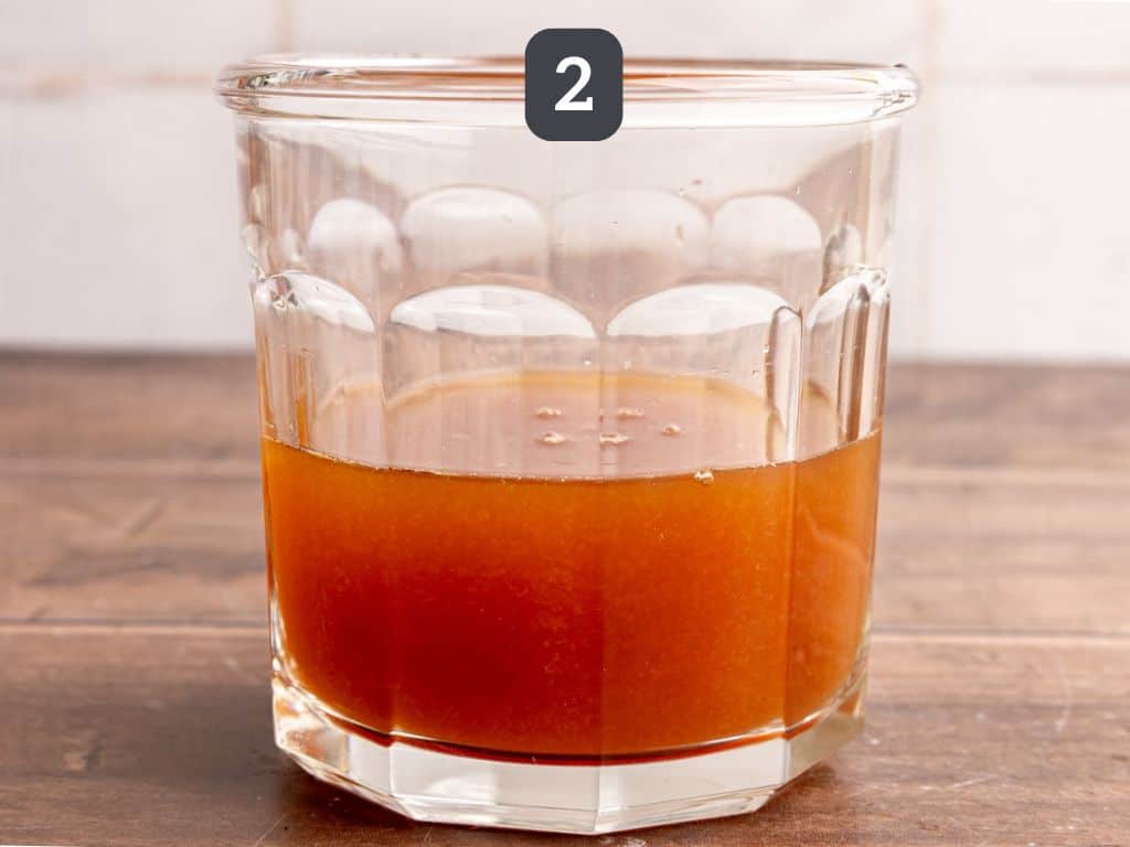 Whiskey sour mocktail step 2 - mix the tea with the lemon juice and syrup.