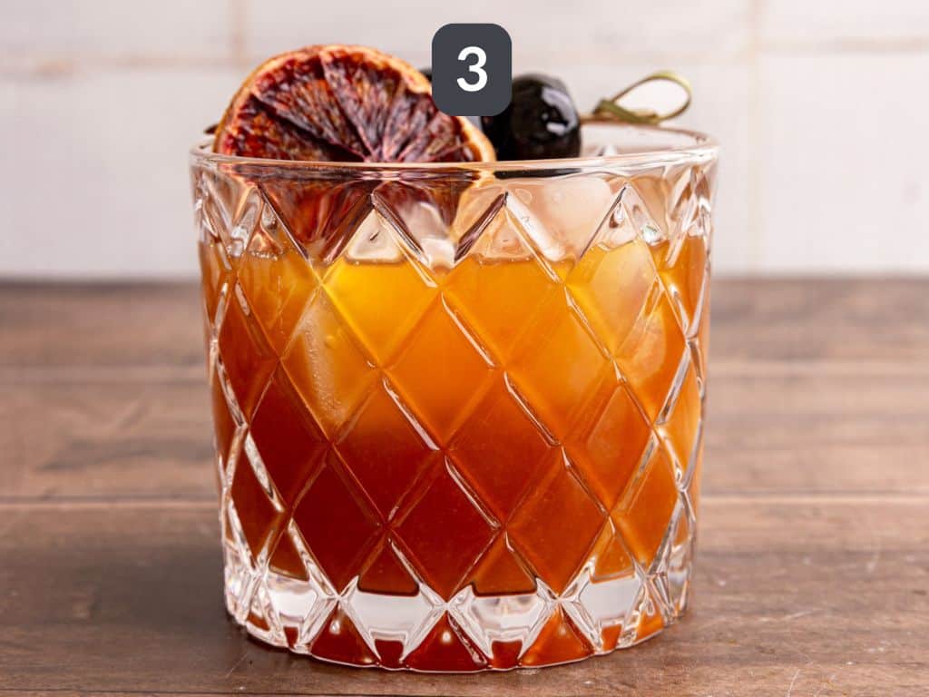 Whiskey sour mocktail step 3 - serve over ice with garnishes.