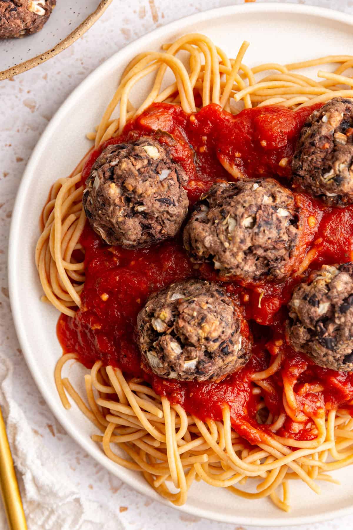 A plate of spaghetti and seitan meatballs.
