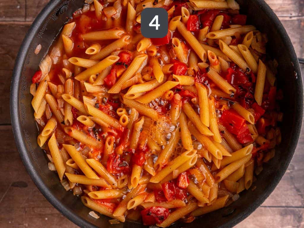 Vegan chorizo pasta step 4 - add the pasta, tomatoes, and broth and boil.