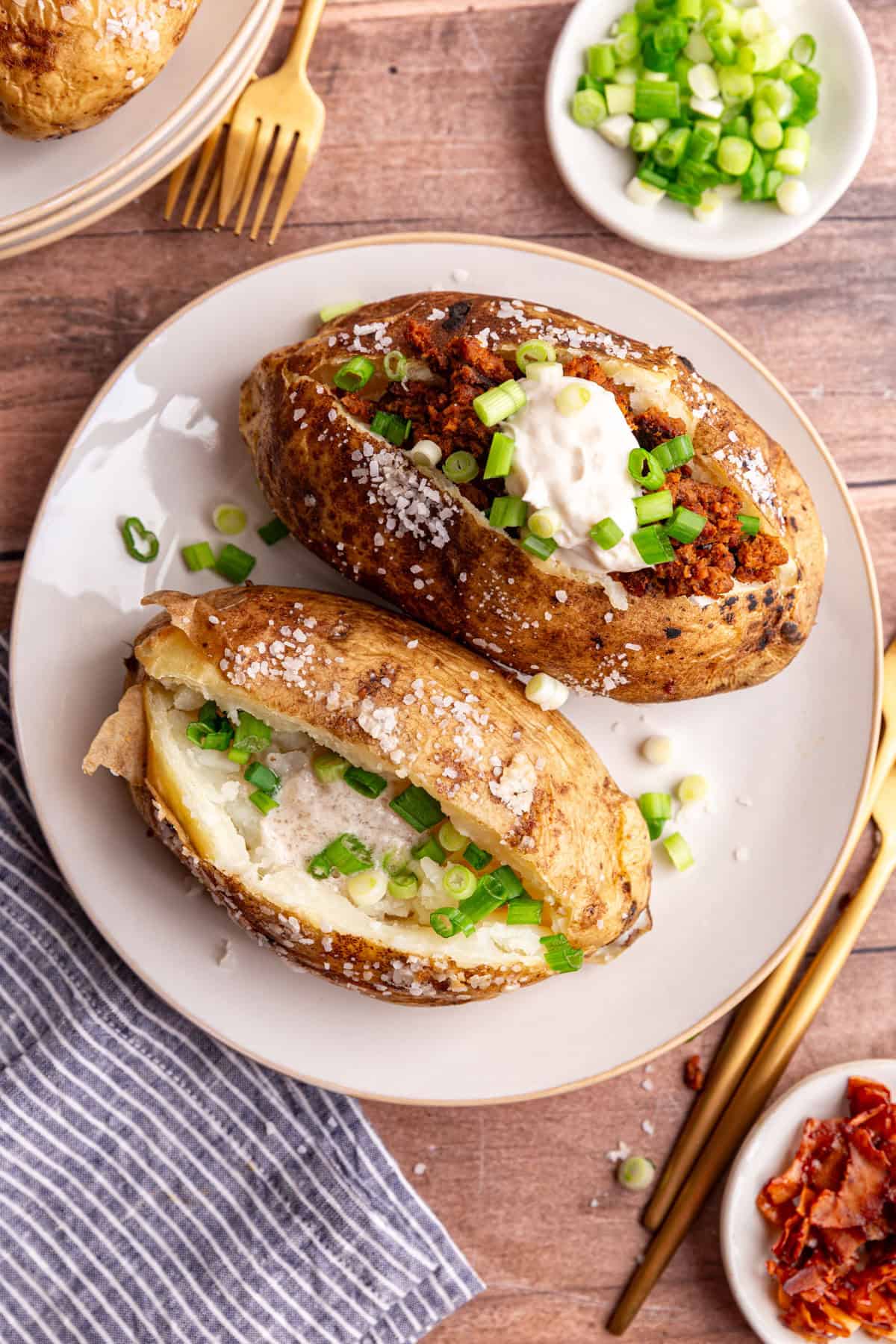 A plate of two loaded vegan baked potatoes.