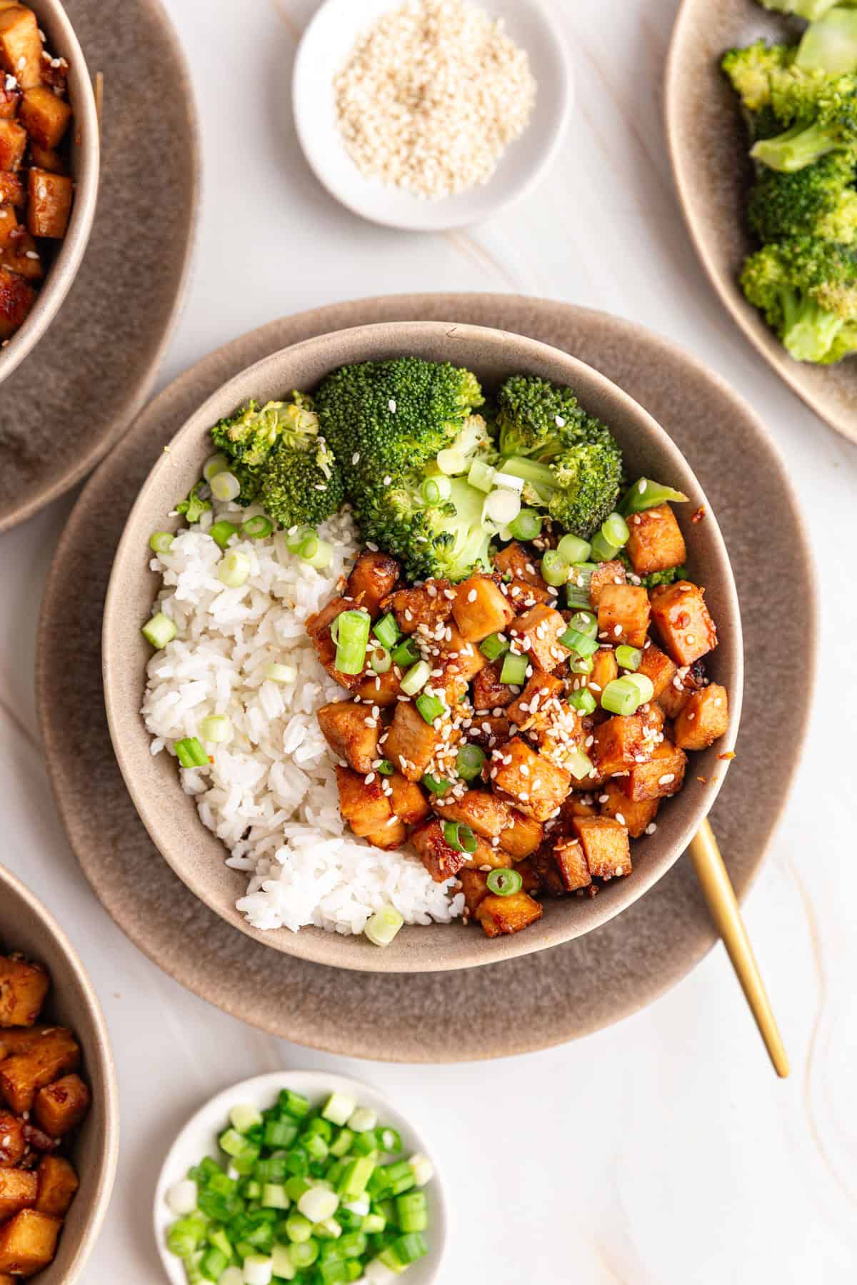 A bowl of Honey Soy Garlic Tofu served with rice and broccoli.