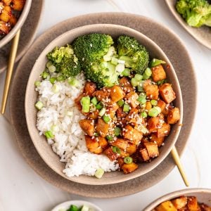 A bowl of Honey Soy Garlic Tofu served with rice and broccoli.