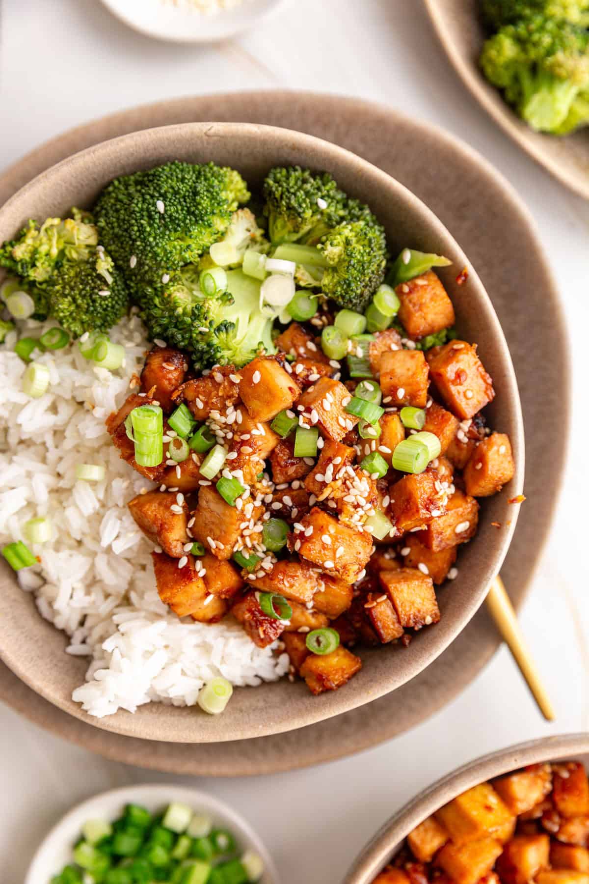 A bowl of Honey Soy Garlic Tofu served with rice and broccoli.