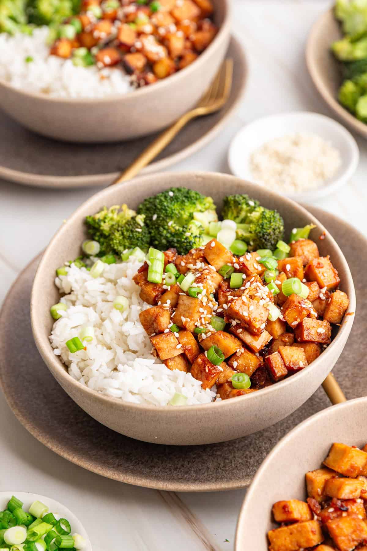 A bowl of Honey Soy Garlic Tofu served with rice and broccoli.
