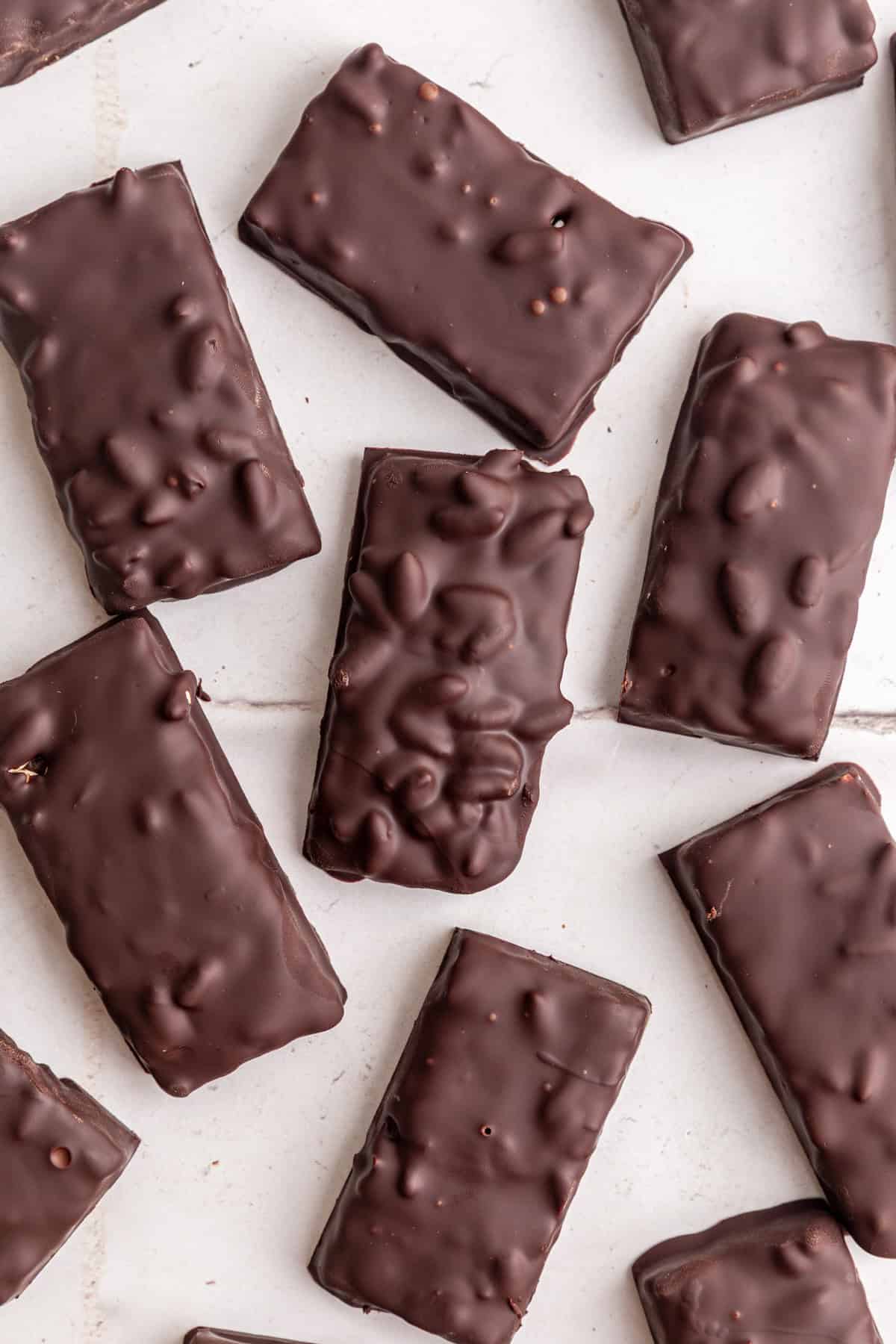 Freshly made vegan 100 grand bars on a countertop.