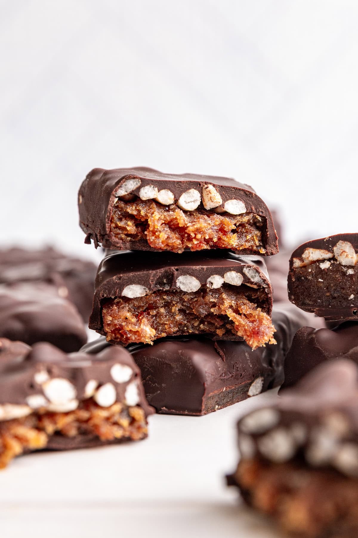 A vegan 100 grand bar broken in half to see the caramel and rice center.